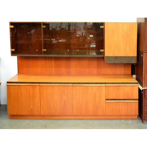 1393 - A teak wall unit, c1970,  with smoked glass upper doors, 142cm h; 50 x 180cm