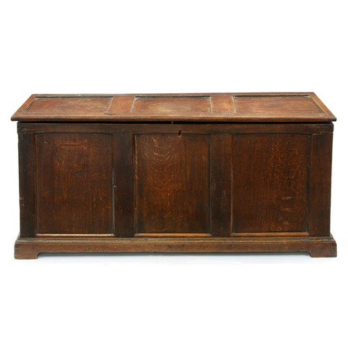 1306 - A late 17th c style oak three panel blanket chest, hinged panel and conforming front on shallow apro... 