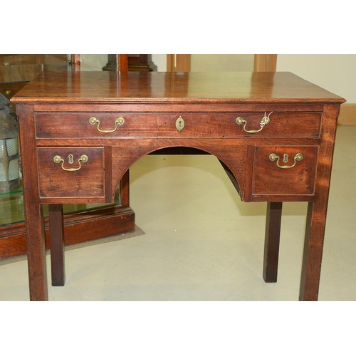 1243 - A George III mahogany lowboy, with moulded top and fitted three cockbeaded drawers to the arched apr... 