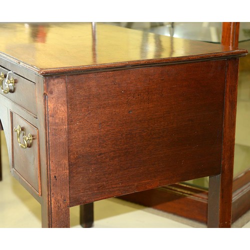 1243 - A George III mahogany lowboy, with moulded top and fitted three cockbeaded drawers to the arched apr... 