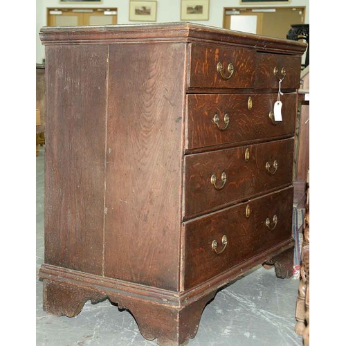 1307 - A George III oak chest of drawers, c1780, the rectangular top with moulded lip above two short over ... 