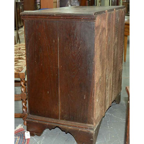 1307 - A George III oak chest of drawers, c1780, the rectangular top with moulded lip above two short over ... 