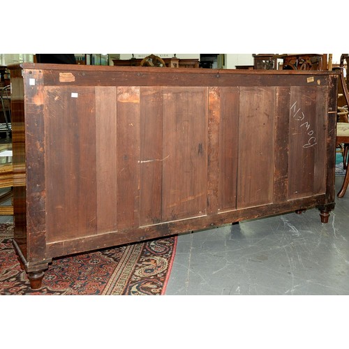 1351 - A George IV rosewood breakfront bookcase, with reel mouldings and fitted with shelves enclosed by pa... 