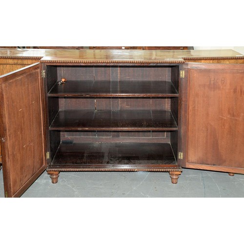 1351 - A George IV rosewood breakfront bookcase, with reel mouldings and fitted with shelves enclosed by pa... 