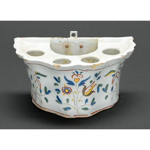122 - A French polychrome faience bough pot, late 18th c, painted in a naïve hand with flowers, 20cm l... 