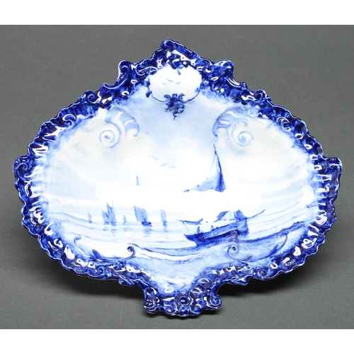 70 - A Royal Crown Derby blue and white shell shaped dish, 1900, painted with fishing boats, 25cm l, prin... 