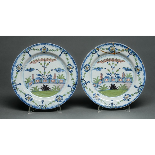 74 - A pair of English Delftware polychrome plates, London, c1785-90, painted with a stylised tree, ferns... 