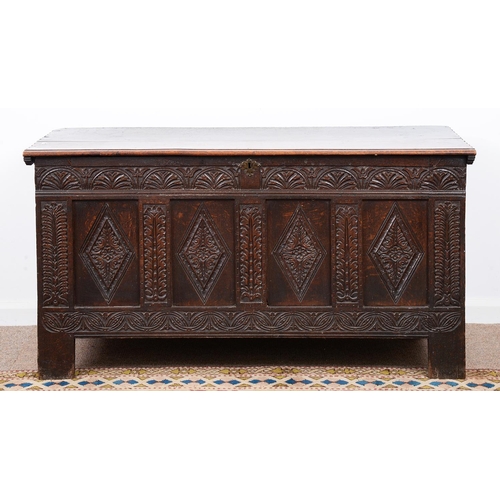 963 - A Charles II oak chest, carved with lunettes above four lozenge panels between leaves, the sides as ... 