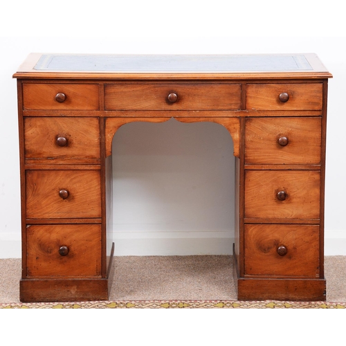 964 - A Victorian mahogany kneehole desk, the leather inlet top with ovolo lip above nine drawers, 78cm h;... 