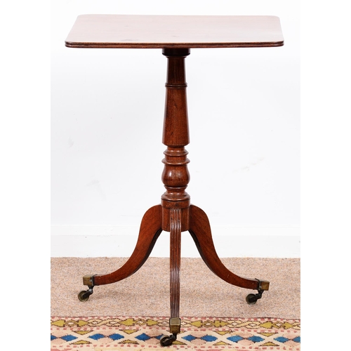 974 - A George III mahogany tripod table, the oblong top on lotus turned pillar and reeded legs with brass... 