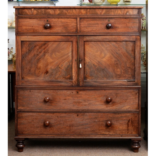 980 - A Victorian mahogany linen press, fitted with trays and enclosed by panelled doors between drawers, ... 