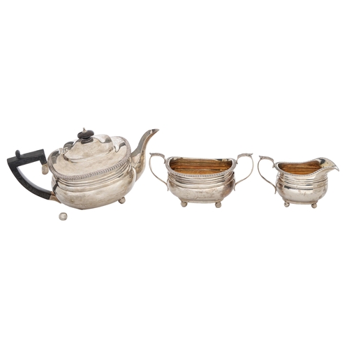 377 - A George V three piece silver tea service, with gadrooned rim, on ball feet, teapot 16cm h, by The G... 