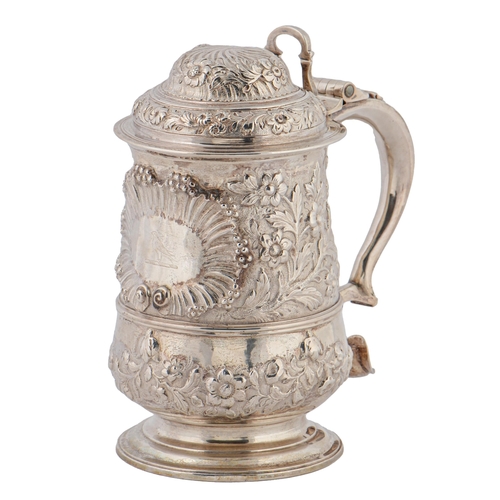 386 -  A George III silver tankard,  crisply but later chased with flowers and festoons centred by a shell... 