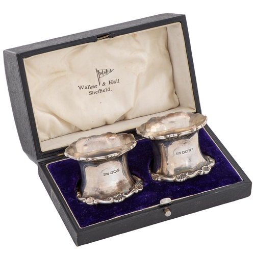 407 - A pair of George V silver napkin rings, spool shaped, with applied border, by Walker & Hall Ltd,... 