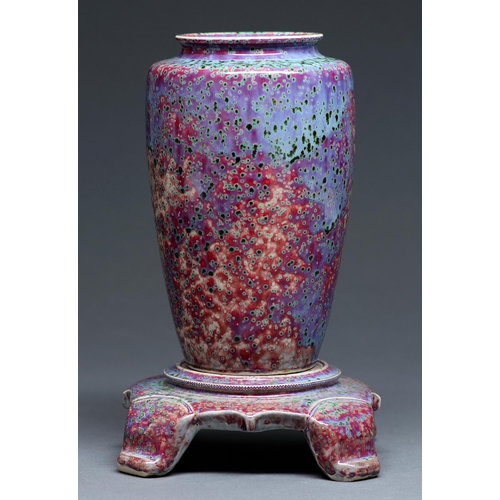 497 - A Ruskin flambe glazed vase and stand, 1926, the vase of shouldered form and covered in a fine mottl... 