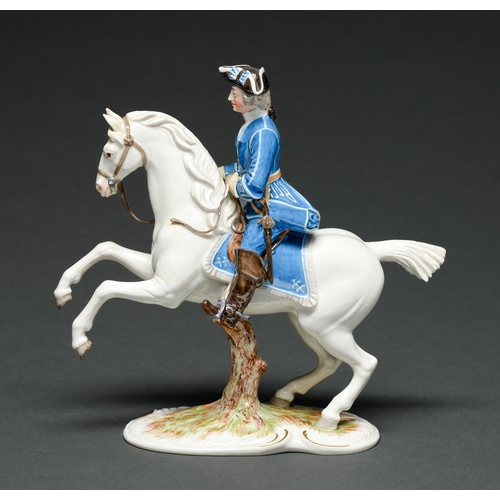 557 - A Nymphenberg Spanish riding school equestrian figure,  the officer in blue uniform with black ... 