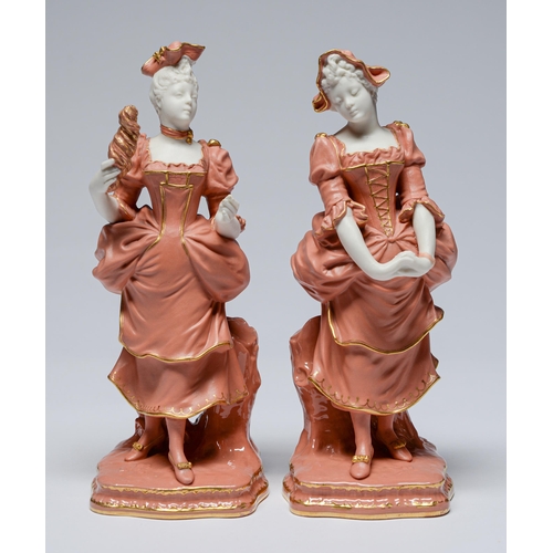 565 - A pair of Mintons white and coral parian figures,  standing before a stump on glazed base , ear... 