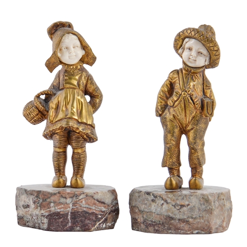 696 - C Boilly.  A pair of gilt bronze and ivory statuettes of a school boy and girl, early 20th c,  on ma... 