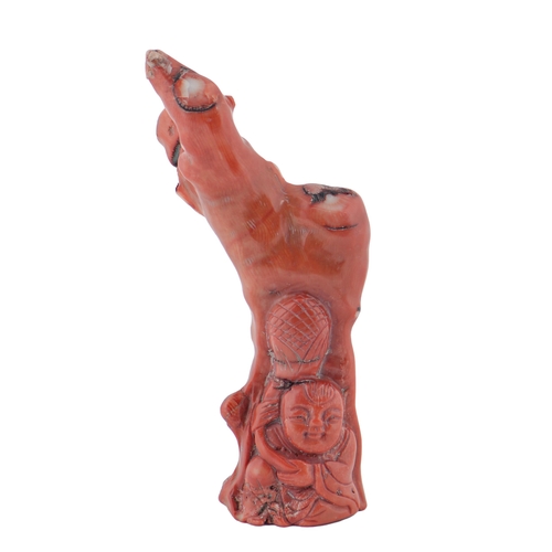 711 - A Chinese coral carving of Budai beneath a tree, 15cm h