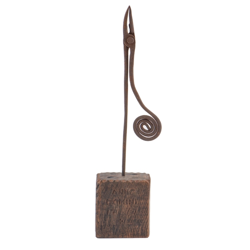 758 - A wrought iron rush nip, on wood block, 41.5cm h