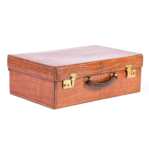 782 - A crocodile hide dressing case, early 20th c, marked on gilt brass locks Finnegans Ltd London, key, ... 