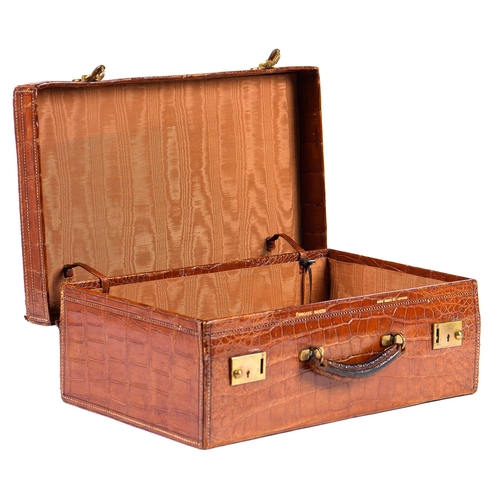 782 - A crocodile hide dressing case, early 20th c, marked on gilt brass locks Finnegans Ltd London, key, ... 