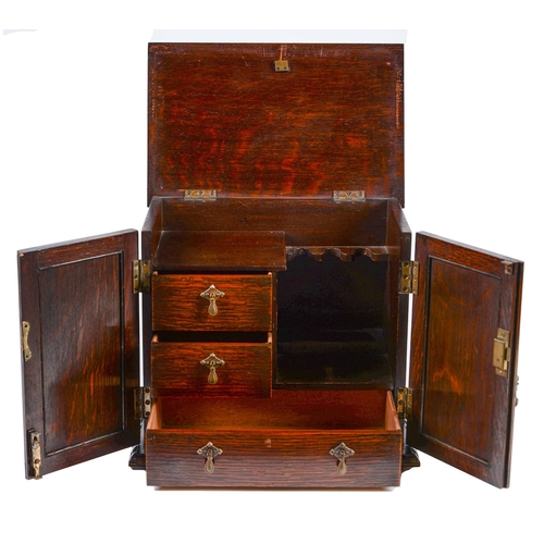 783 - An oak smoker's cabinet, early 20th c, the fitted interior enclosed by panelled doors, 28.5cm h; 20 ... 