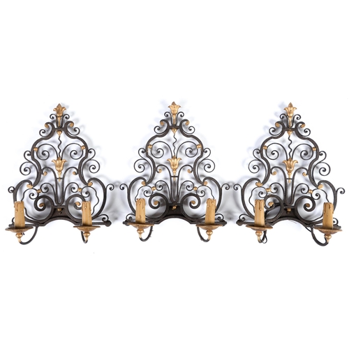 937 - A set of three wrought iron wall sconces, 20th c, in early 18th c style, partly gold painted, 42cm h... 