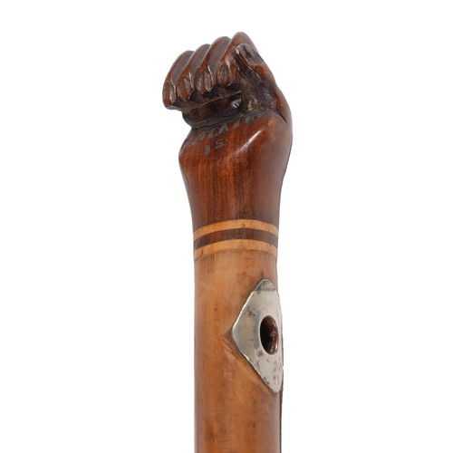 753 - A malacca cane, Pitcairn Island, early 20th c, with carved hardwood clenched fist pommel, stamped in... 