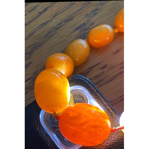 102 - A necklace of amber beads, 67g