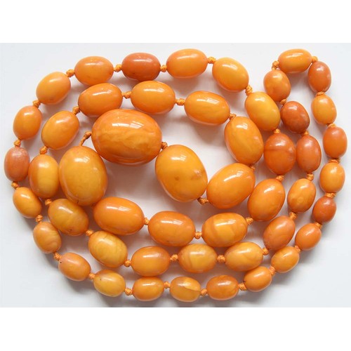 102 - A necklace of amber beads, 67g