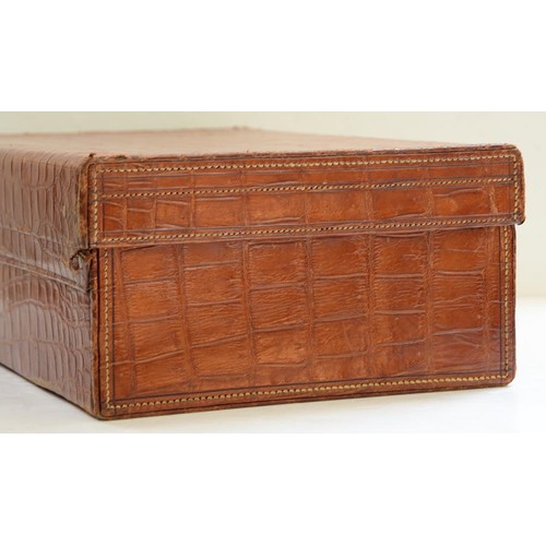 782 - A crocodile hide dressing case, early 20th c, marked on gilt brass locks Finnegans Ltd London, key, ... 