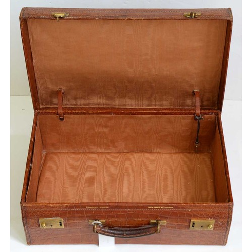 782 - A crocodile hide dressing case, early 20th c, marked on gilt brass locks Finnegans Ltd London, key, ... 