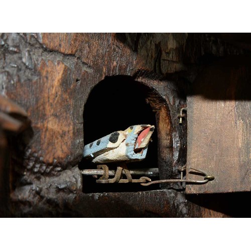 899 - A Swiss limewood cuckoo clock, late 19th c, in the form of a rocky crag surmounted by an eagle swoop... 