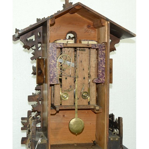 900 - A Swiss walnut cuckoo clock, late 19th c, in the form of a chalet embowered with fruiting vines cent... 