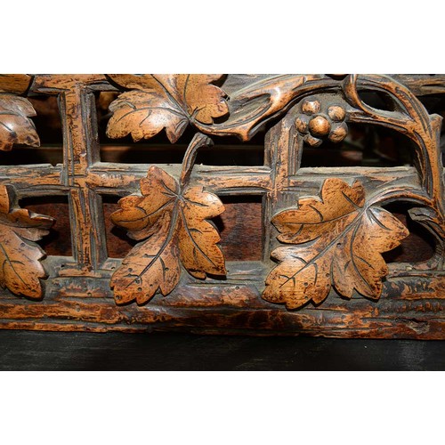 900 - A Swiss walnut cuckoo clock, late 19th c, in the form of a chalet embowered with fruiting vines cent... 