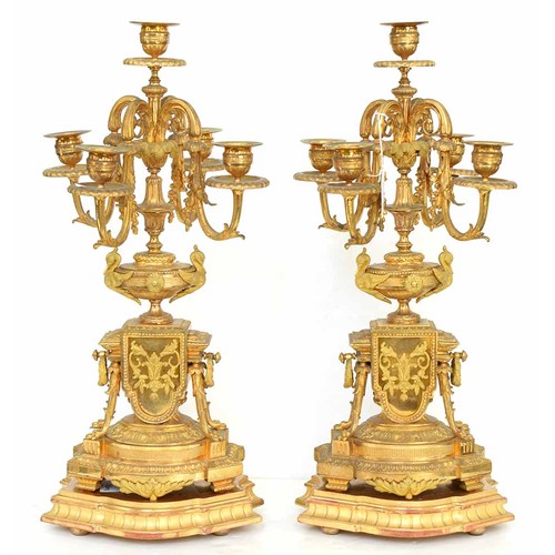 948 - An ormolu garniture de cheminee, 19th c, the ornate case with urn finial with bird handles and pinea... 