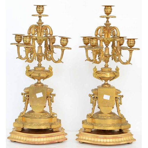 948 - An ormolu garniture de cheminee, 19th c, the ornate case with urn finial with bird handles and pinea... 