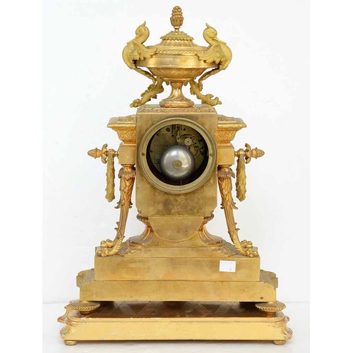 948 - An ormolu garniture de cheminee, 19th c, the ornate case with urn finial with bird handles and pinea... 