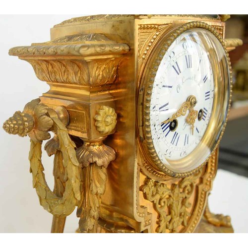 948 - An ormolu garniture de cheminee, 19th c, the ornate case with urn finial with bird handles and pinea... 