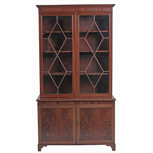 570 - A mahogany bookcase, early 19th c, with stepped cornice and figured frieze, fitted with adjustable s... 