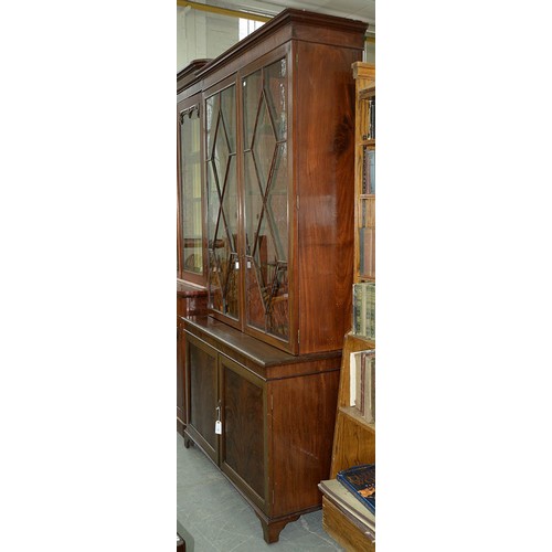 570 - A mahogany bookcase, early 19th c, with stepped cornice and figured frieze, fitted with adjustable s... 