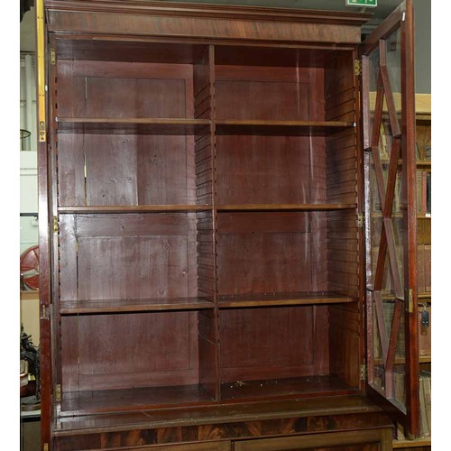 570 - A mahogany bookcase, early 19th c, with stepped cornice and figured frieze, fitted with adjustable s... 