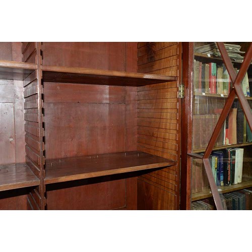 570 - A mahogany bookcase, early 19th c, with stepped cornice and figured frieze, fitted with adjustable s... 