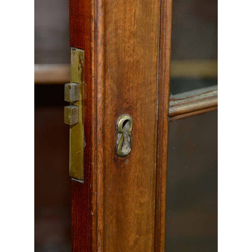 570 - A mahogany bookcase, early 19th c, with stepped cornice and figured frieze, fitted with adjustable s... 