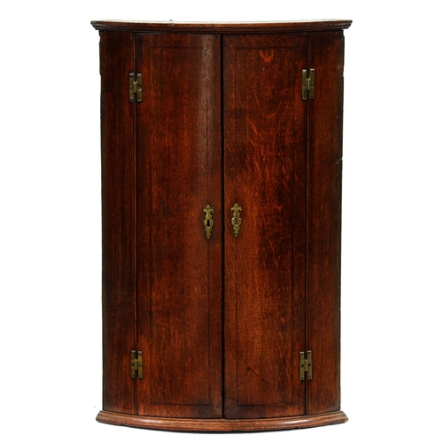 585 - A George III bow fronted oak hanging corner cupboard, brass H-hinges, 97cm h; 37 x 61cm and two Vict... 