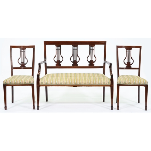 607 - An Edwardian mahogany and broken line inlaid salon suite, comprising settee with three lyre splats a... 