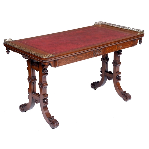 656 - An early Victorian Elizabethan revival oak writing table, the leather inlet oblong top with pierced ... 