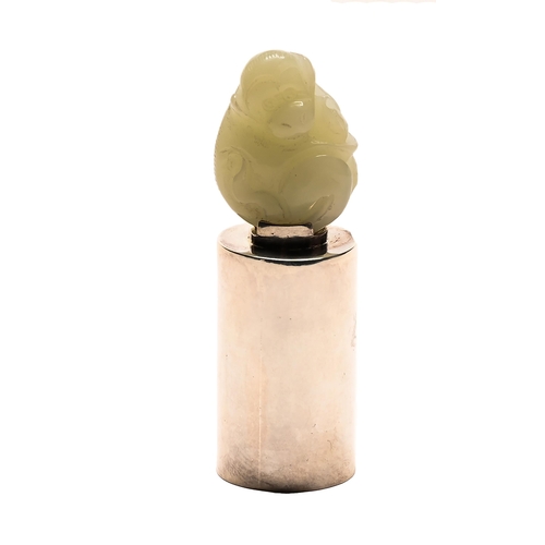 198 - A miniature jade carving of a monkey on affixed tubular silver stand, 20th c, 22mm h overall... 