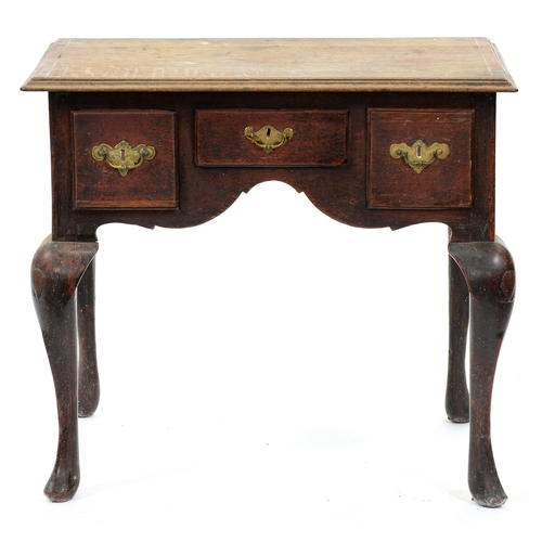 529 - A George II oak lowboy, with line inlaid top, three moulded drawers to the arched apron, on shell ca... 